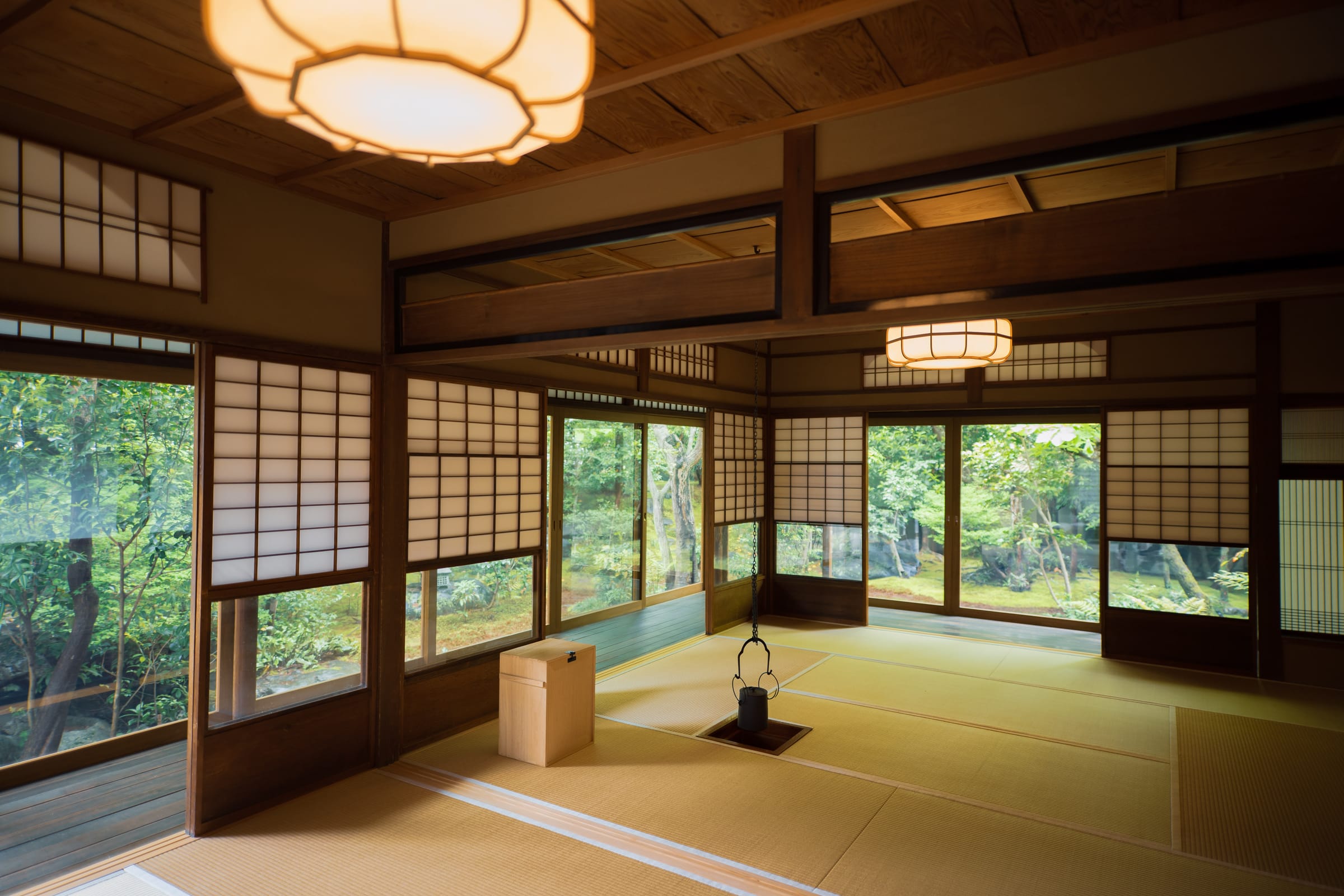 Traditional Japanese tatami room with shoji screens opening onto a lush garden